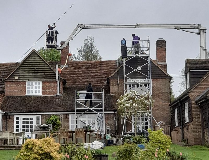 The Moss Cleaners using cherry picker and scaffolding to clean roof safely and professionally in Wellingborough, Northamptonshire